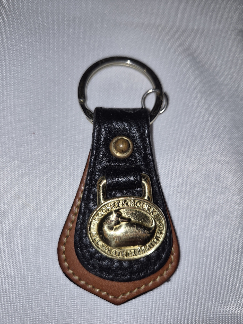 Dooney & Bourke Black and Brown Leather Key Fob with Brass Medallion
